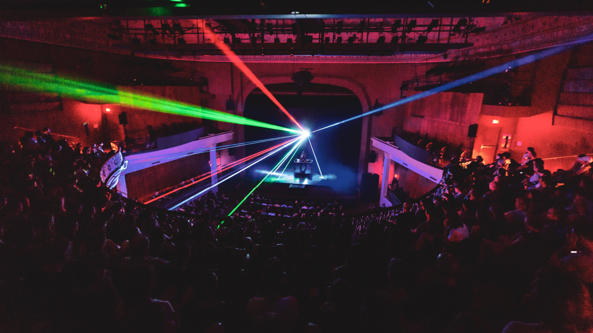 Laser beams shooting all directions in theatre space