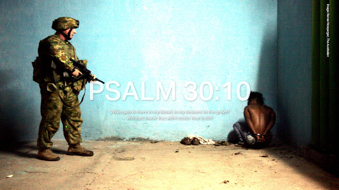 A youth detained under suspicion of burning houses belonging to pro Prime Minister Alkatiri supporters is held at gun point by an Australian soldier in East Timor in 2006. 